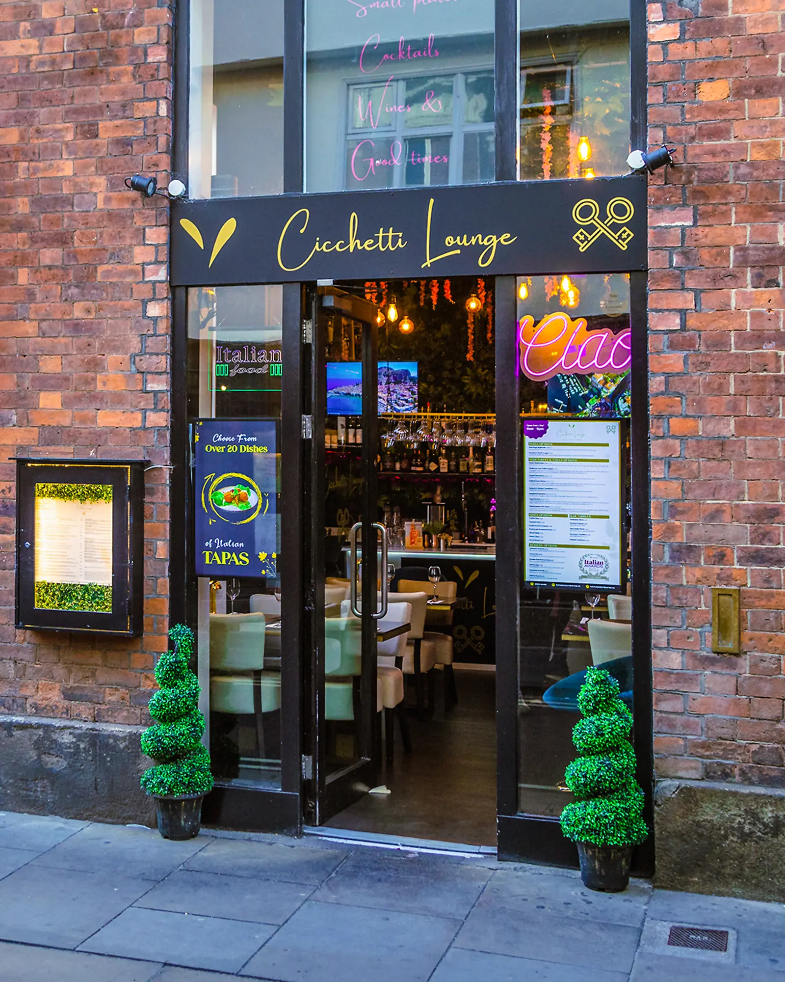 cicchetti-lounge-york-italian-tapas-restaurant-exterior Cicchetti Lounge entrance on Low Petergate in York, with gold signage, brick frontage and outdoor seating.